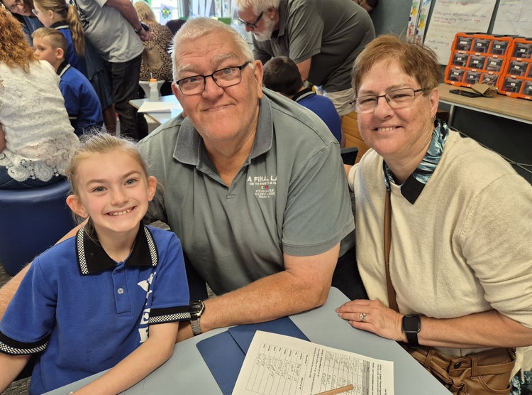 Student with their grandparents for Grandparents' Day Celebrations