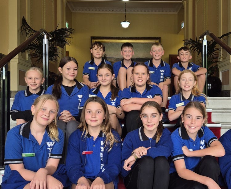 2025 student leadership team sitting on the stairs at the GRIP Conference
