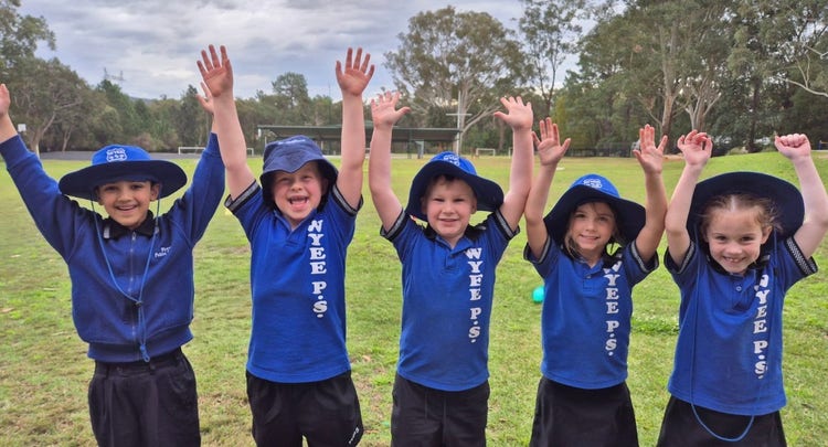 Image of five cheerful students on the playground.