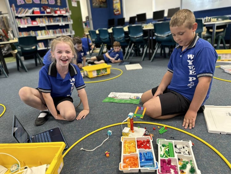 Image of students happily using the LEGO Spike kits.